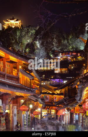 Busy Lijiang Old Town, UNESCO World Heritage Site, at night with Lion Hill and Wan Gu Tower, Lijiang, Yunnan, China, Asia Stock Photo