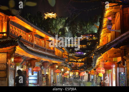 Busy Lijiang Old Town, UNESCO World Heritage Site, at night with Lion Hill and Wan Gu Tower, Lijiang, Yunnan, China, Asia Stock Photo