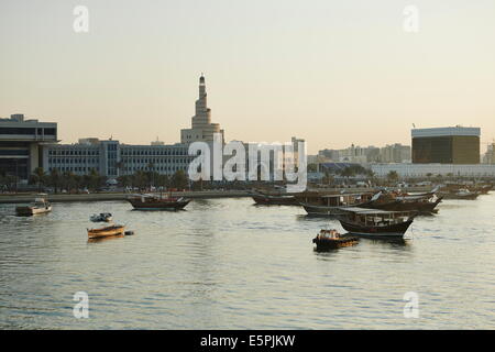 View from The Museum of Islamic Arts towards old Doha and The Islamic Centre with dhows moored in the Harbour, Doha, Qatar Stock Photo