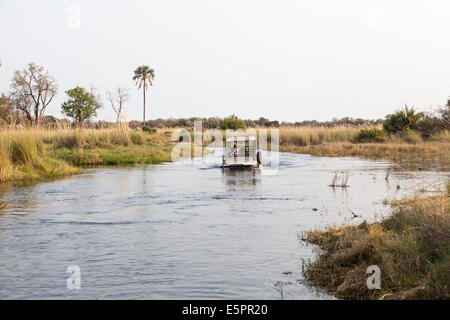 Half submerged safari jeep fording a deep river in the Okavango Delta, Botswana Stock Photo