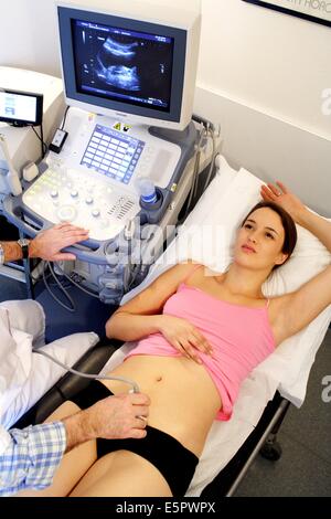 Woman undergoing pelvic ultrasound scan. Stock Photo