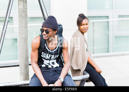 African man sitting with girlfriend in the city Stock Photo