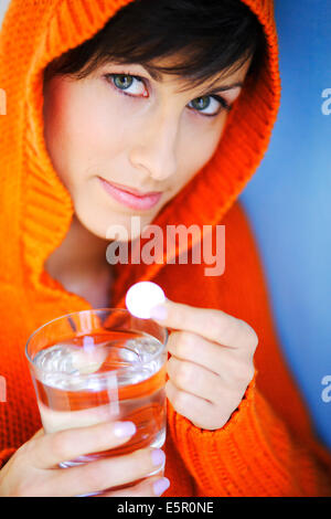 Woman taking an effervescent aspirin tablet. Stock Photo