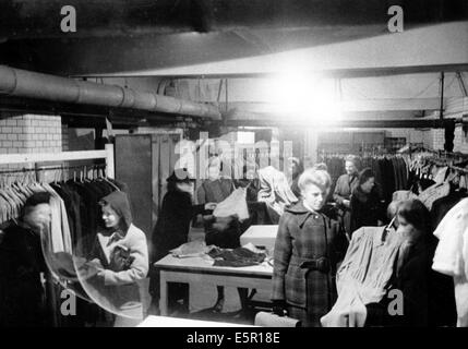 The picture from a Nazi news report shows women shopping for clothes in the basement of a boutique after an air raid in Berlin, Germany, October 1944. The original text on the back of the picture reads: 'Life in Berlin today. A big Berlin fashion boutique continues with its basement shopping. Just like this store, many others are operating in basements or other parts of their stores that have escaped damage during the bombing terror.' Fotoarchiv für Zeitgeschichte - NO WIRE SERVICE Stock Photo