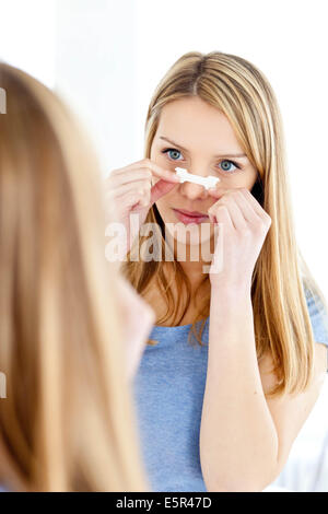 Young woman wearing a nasal strip. Stock Photo