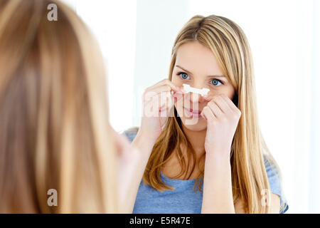 Young woman wearing a nasal strip. Stock Photo