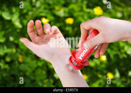 Woman using an aspivenin, a poison sucker device against stings and bites (Bee, wasp, snake). Stock Photo