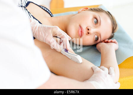 Implanon contraceptive implant removal - Stock Image - C011/7408