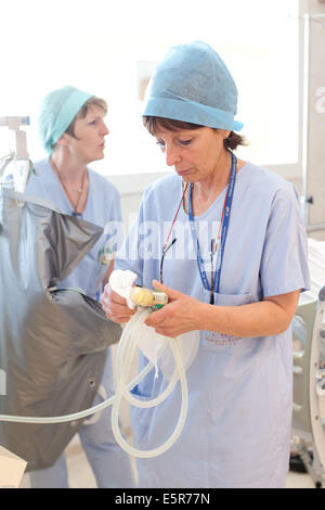 Auxiliary nurses cleaning medical material, Recovery room, Bordeaux hospital, France. Stock Photo