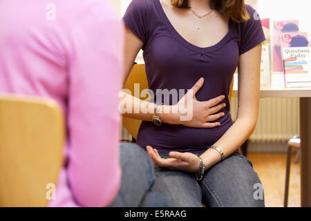 Teenage girl with bellyache. Stock Photo