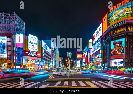 SAPPORO, JAPAN - OCTOBER 17, 2012: Traffic passes through the Susukino District. Susukino is one of the three major red-light di Stock Photo