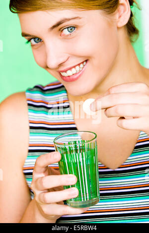 Woman taking vitamin C effervescent tablet. Stock Photo