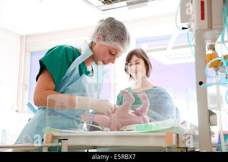 Midwife taking care of a newborn baby, Maternity department, Cochin hospital, Paris, France.