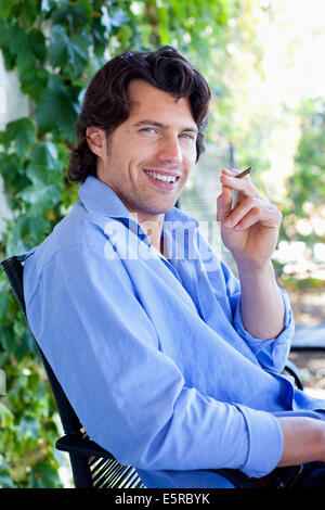 Man smoking cigarillo. Stock Photo