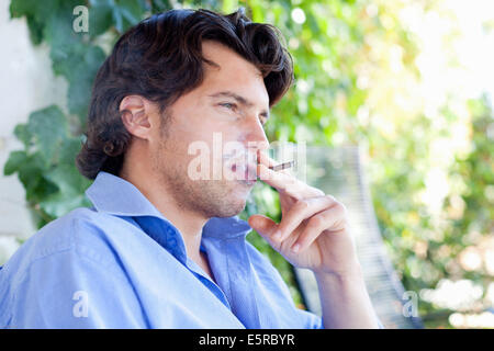 Man smoking cigarillo. Stock Photo