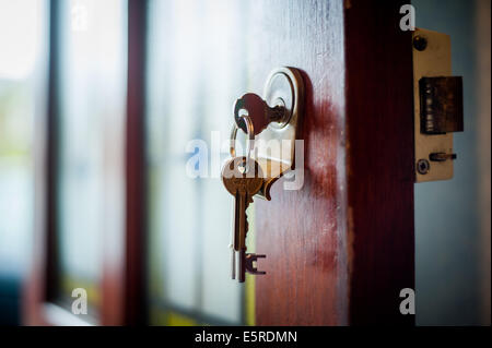 Key in a front door Stock Photo