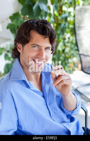 Man smoking cigarillo. Stock Photo