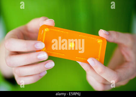 Woman holding Norlevo morning-after pill (emergency contraceptive pill). Stock Photo