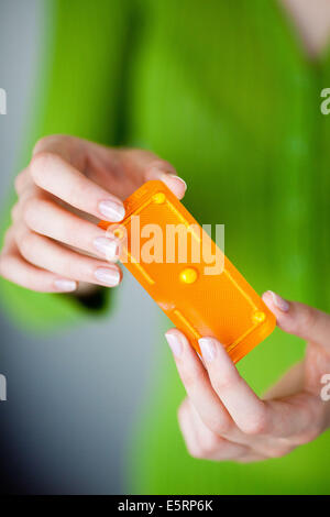 Woman holding Norlevo morning-after pill (emergency contraceptive pill). Stock Photo