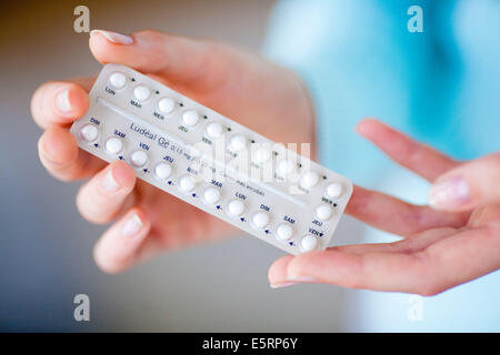 Woman with generic contraceptive pills. Stock Photo