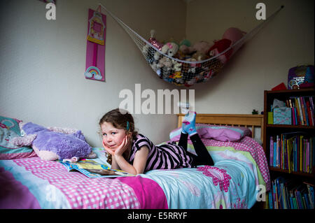 Girl of 8,9,10 reading in her bedroom Stock Photo