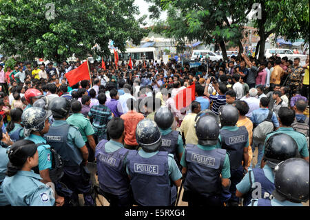 Dhaka, Bangladesh. 5th August, 2014. Bangladeshi protesters in face to face with riot police. The unpaid apparel workers of Tuba Group on Tuesday lead siege to the building of Bangladesh Garment Manufactures & Exporters Association (BGMEA) at Karwan Bazar in Dhaka to press home their demand of payment of wages arrears. Credit:  Mohammad Asad/Pacific Press/Alamy Live News Stock Photo