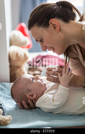 4 months old baby boy having his nose cleared with a nose-blower. Stock Photo