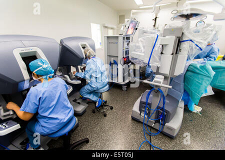 Hysterectomy performed by the telesurgery robot Da Vinci, which four articulated arms and camera are controlled at distance by Stock Photo