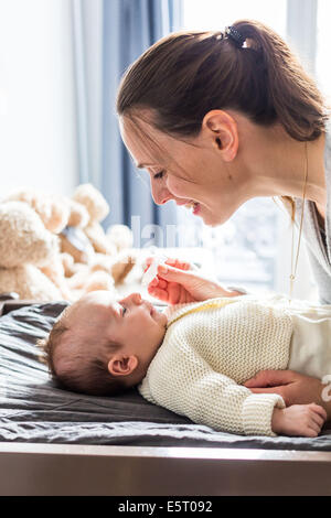 3 month old baby boy having his nose cleared with physiological saline solution drops. Stock Photo