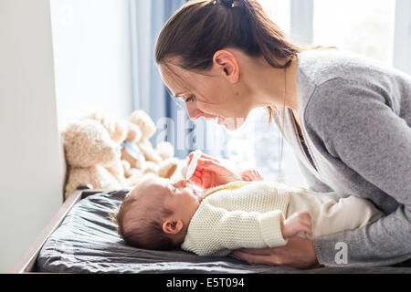 3 month old baby boy having his nose cleared with physiological saline solution drops. Stock Photo