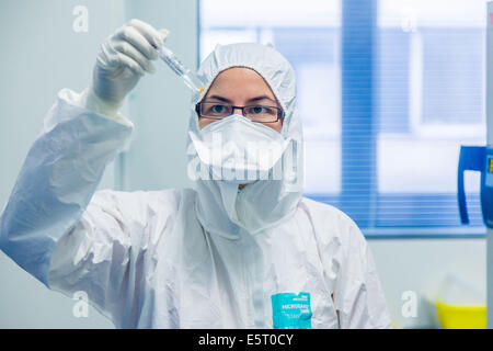 Researcher holding a test tube containing hepatitis virus in a high security laboratory of the Centre de Référence National des Stock Photo