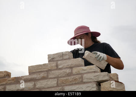 Female brickie in Southport, Merseyside, UK. August, 2014.   Ms Clair Skidmore,  bricklaying at the Flower Show as preparations get underway Victoria Park showgrounds for the UK’s largest independent flower show.   It was originally started in 1924 by the local council, but since 1986 it has been operated by Southport Flower Show company, which is a registered charity. It is held annually for four days in late August.
