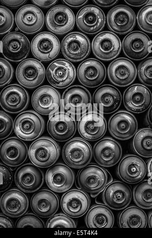 Used spray paint cans stacked up in Berlin Stock Photo