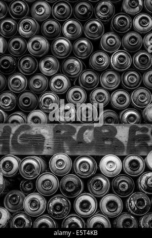 Used spray paint cans stacked up in Berlin Stock Photo