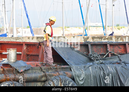 Engineer Supervising The Dredging Of The Causeway Bay Typhoon Shelter, Hong Kong. Stock Photo