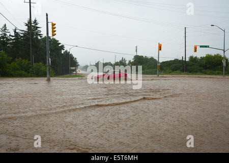 Thunderstorms create flash flooding in Oakville, Ontario turning roads into rivers stranding many & causing millions in damage Stock Photo