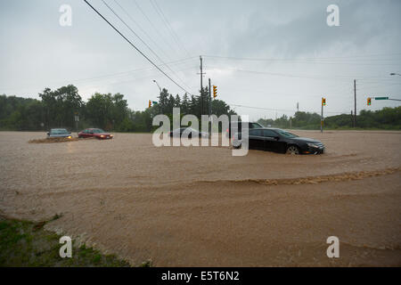 Thunderstorms create flash flooding in Oakville, Ontario turning roads into rivers stranding many & causing millions in damage Stock Photo