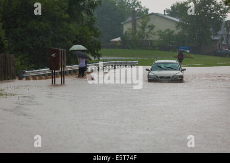 Thunderstorms create flash flooding in Oakville, Ontario turning roads into rivers stranding many & causing millions in damage Stock Photo