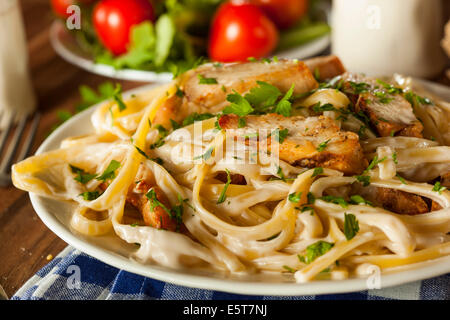 Homemade Fettucini Aflredo Pasta with Chicken and Parsley Stock Photo