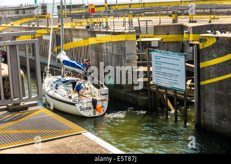 Sail boat navigating the lock gates of Cardiff Bay Barrage Stock Photo