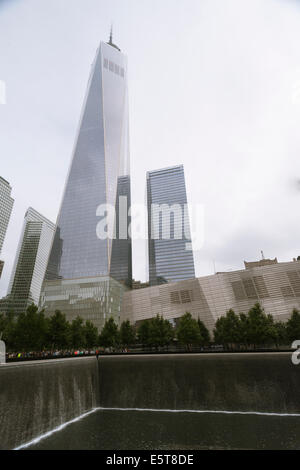 One World Trade Center, left, rises over the National September 11 Memorial & Museum in New York Stock Photo