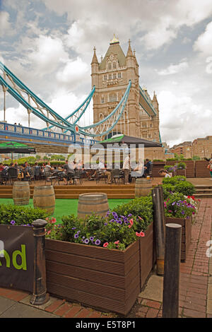 View of Tower Bridge With People in Gardens Photographed from Southwark London UK Stock Photo