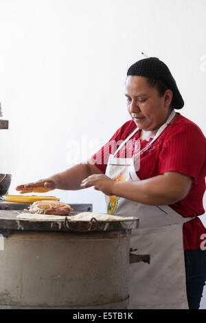 Woman making a torta on a comal at Mi Taquito taquería in the Centro Historico Stock Photo