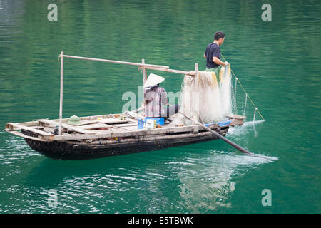 Two men fishing in the waters around Ha Long Bay, Vietnam. Stock Photo