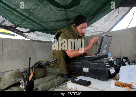 An Israeli female soldier from the Field Intelligence Corps using a computer  to identify locations that were hit by rockets fired from Gaza strip from a roof in the city of Beersheba. The Field Intelligence Corps, is responsible for collecting visual information on the battlefield and rapidly transferring it to other forces. Stock Photo