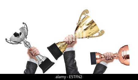 winners holding champion golden, silver and bronze trophies Stock Photo