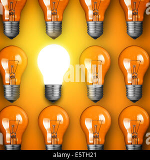 Concept for big idea. Glowing light bulb on orange background Stock Photo