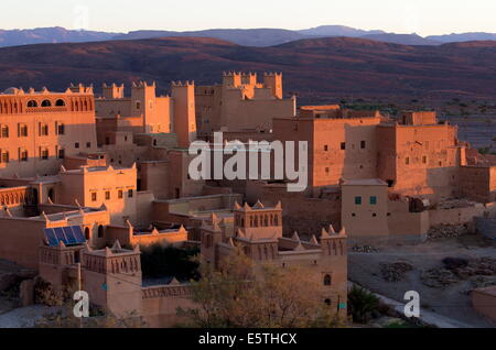Traditional kasbahs (fortified houses) bathed in evening light in the town of Nkob, near the Jbel Sarhro mountains, Morocco Stock Photo