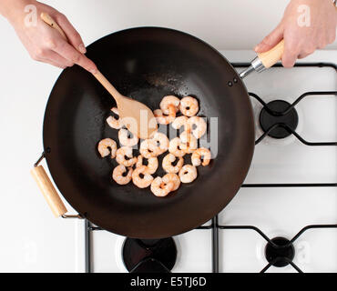 STIR FRYING SHRIMP OR PRAWNS IN A WOK Stock Photo