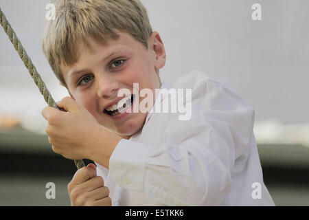Smiling boy having fun on a swing Stock Photo